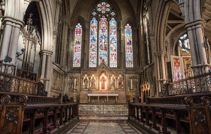 Vista interior de una iglesia con iconos religiosos en las paredes y ventanas vaticano