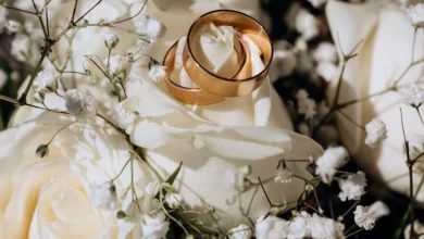 anillos de bodas de oro en la rosa blanca del ramo de la boda